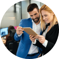 demo-attachment-1590-businesspeople-discussing-while-using-digital-WFGVC3X@2x